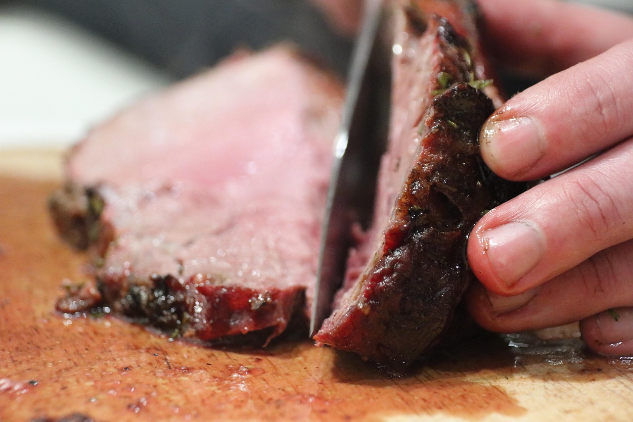 chef cutting into a steak