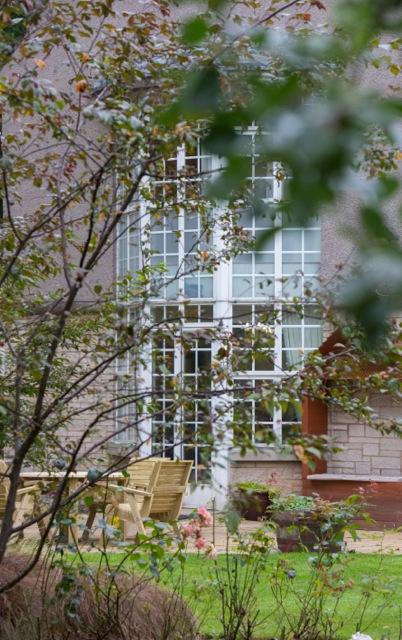 bedroom windows seen through trees in the garden