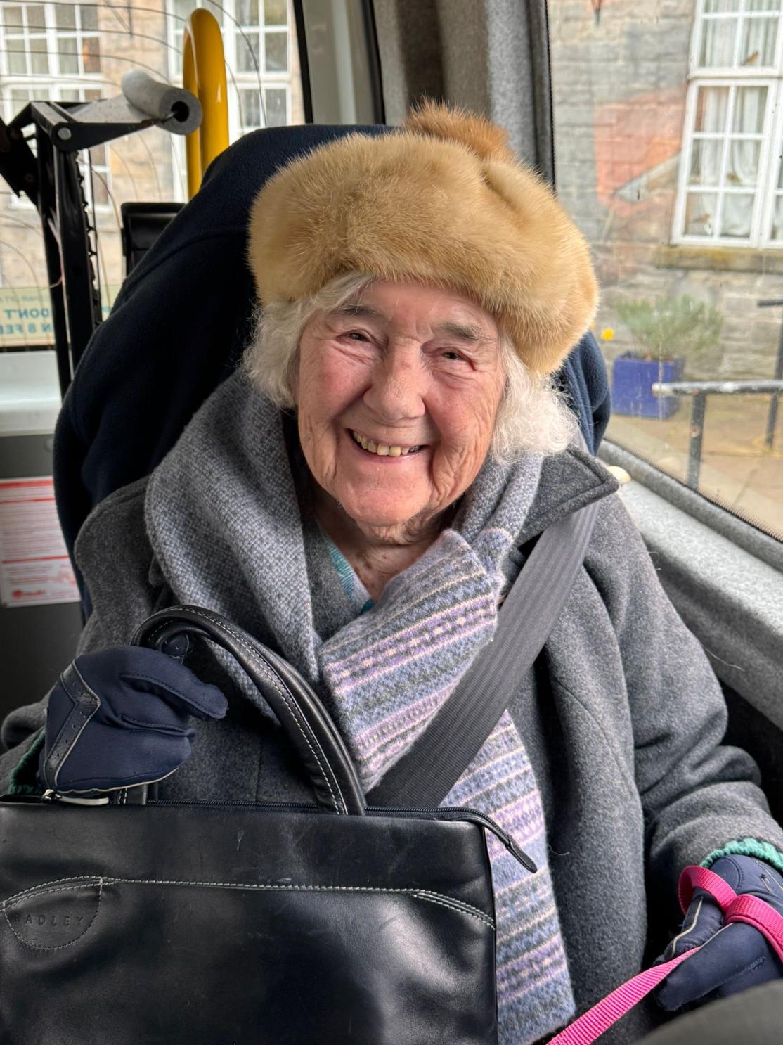 resident smiling in the care home's minibus