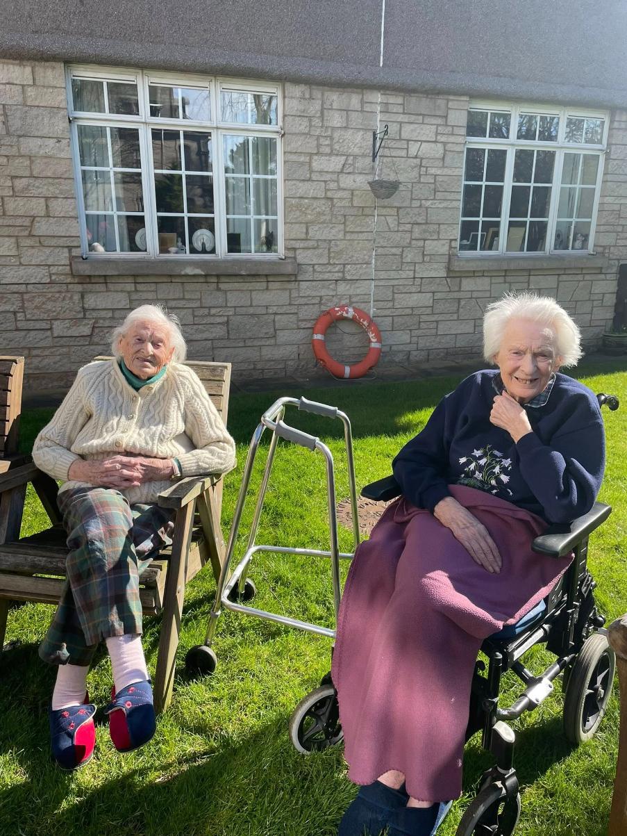 residents sat in the garden sunshine
