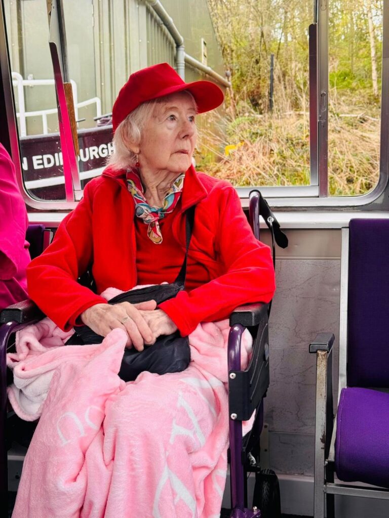elderly woman sat on a canal boat