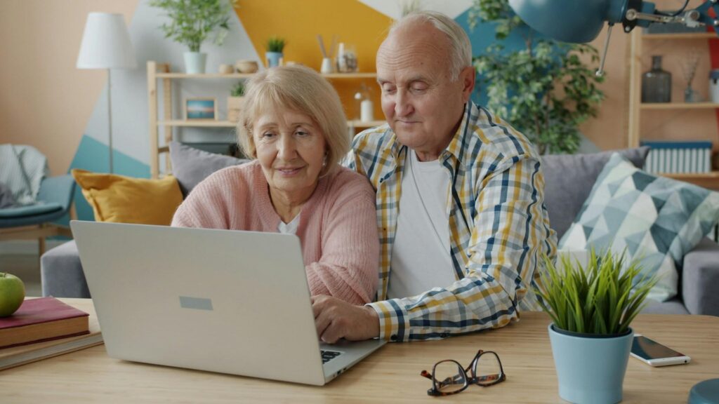elderly couple using a laptop